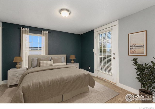 carpeted bedroom featuring access to outside and baseboards