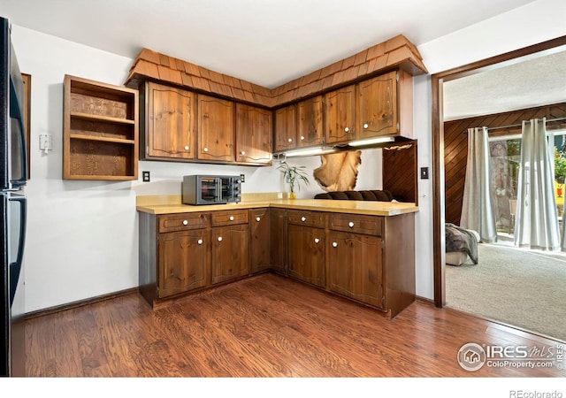 kitchen featuring dark wood-type flooring and stainless steel fridge