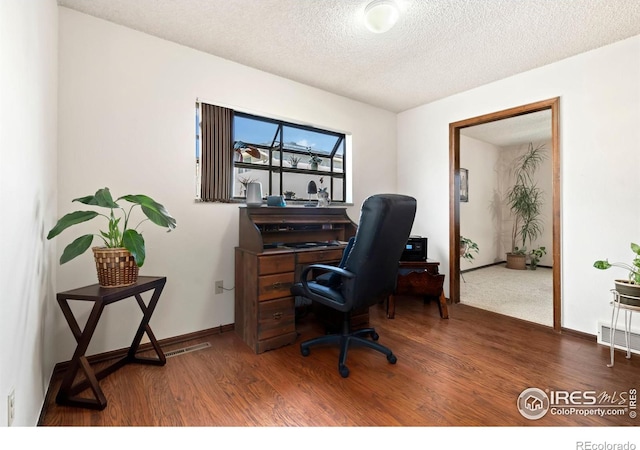 office featuring a textured ceiling and hardwood / wood-style flooring