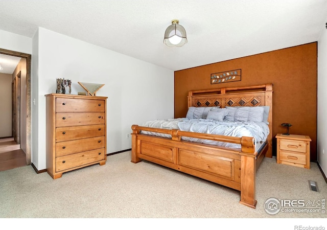 carpeted bedroom featuring a textured ceiling