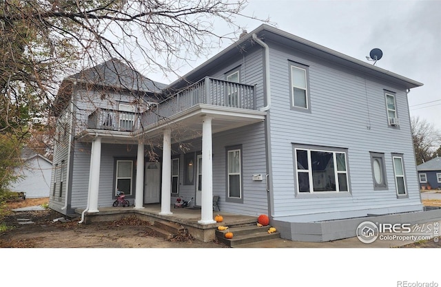 view of front of house with a porch and a balcony