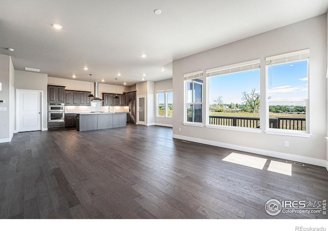 unfurnished living room featuring dark wood-type flooring