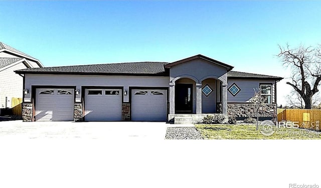 view of front of home with a garage and a front lawn