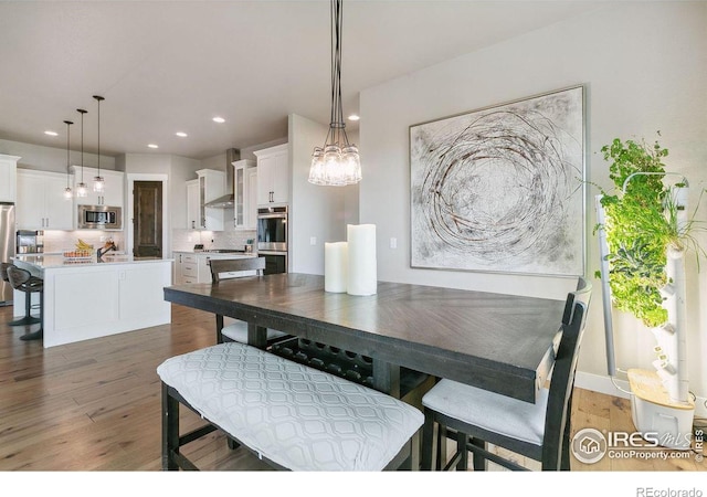 dining area with dark hardwood / wood-style flooring