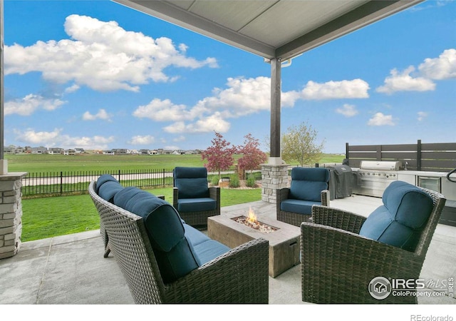 view of patio with area for grilling and an outdoor living space with a fire pit