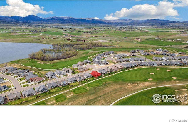 drone / aerial view with a water and mountain view