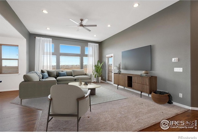 living room featuring hardwood / wood-style floors and ceiling fan