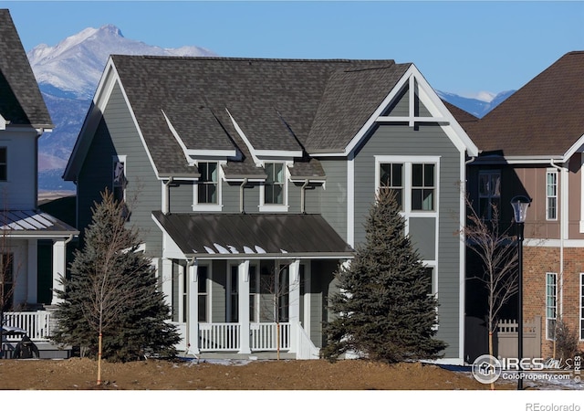 view of front facade featuring a mountain view and covered porch