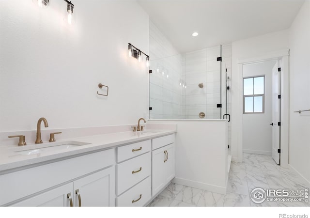 bathroom with vanity and a shower with shower door