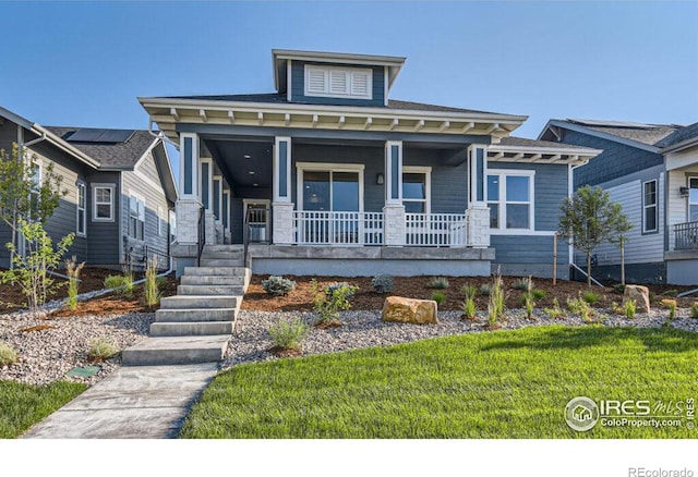 view of front of house featuring a front lawn and covered porch