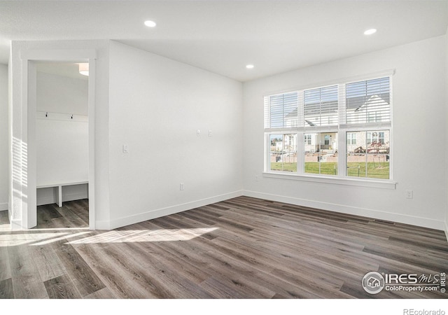 unfurnished room featuring dark hardwood / wood-style floors