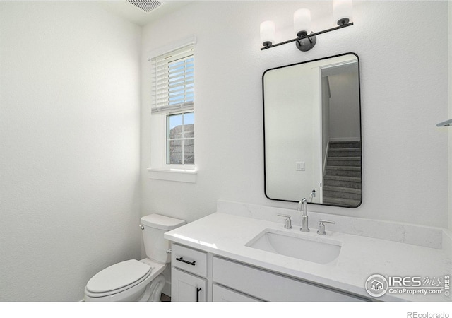 bathroom with toilet and vanity