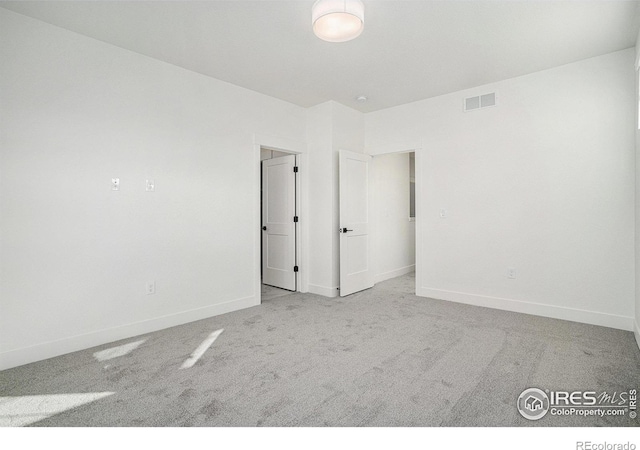 empty room with light colored carpet