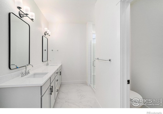 bathroom with vanity, toilet, and a shower with shower door