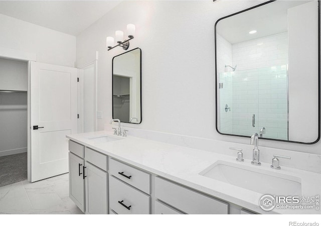 bathroom featuring walk in shower and vanity