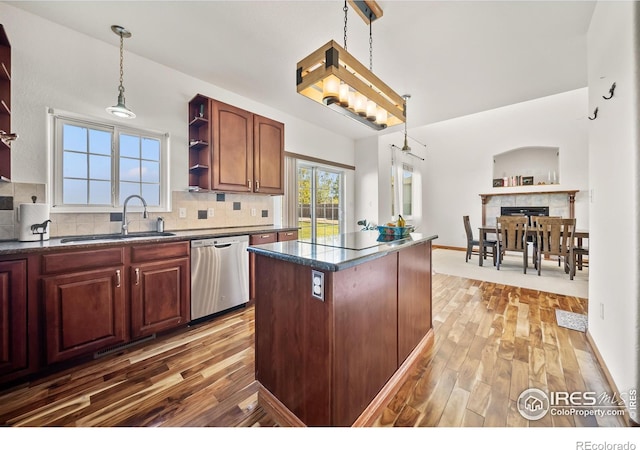 kitchen featuring dark hardwood / wood-style flooring, sink, a kitchen island, and dishwasher