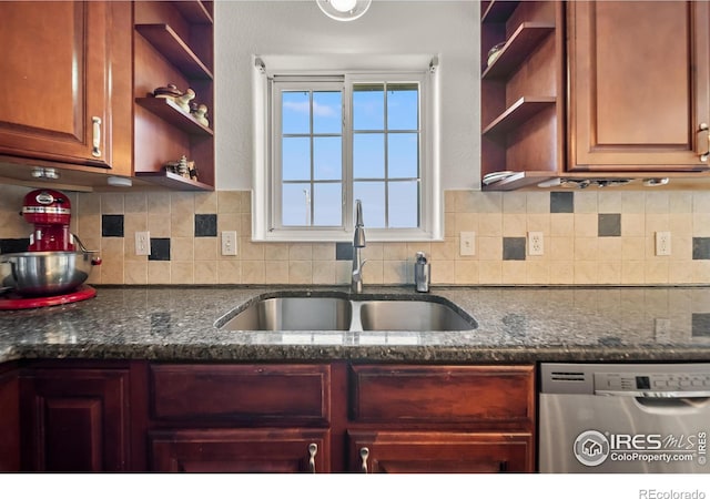 kitchen with dishwasher, dark stone counters, sink, and backsplash