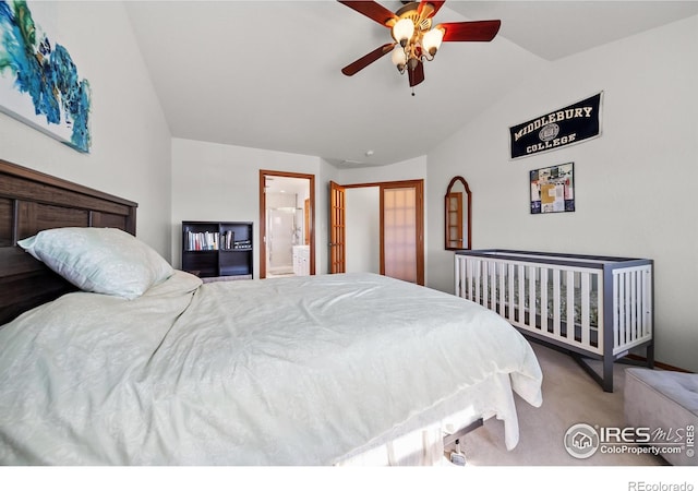 carpeted bedroom featuring ensuite bathroom, ceiling fan, and vaulted ceiling