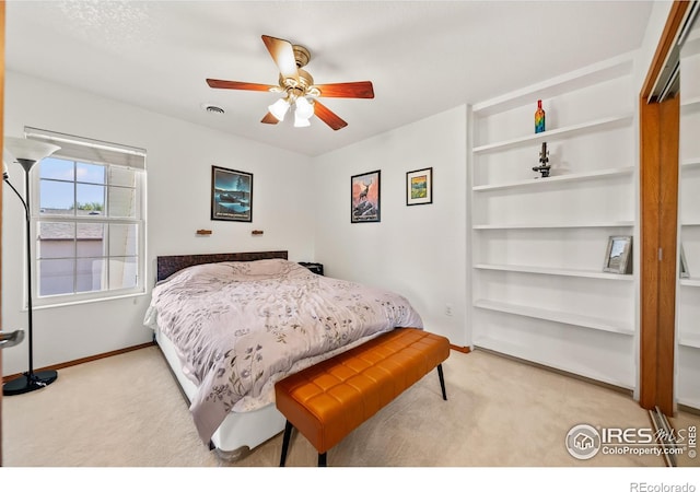 bedroom featuring ceiling fan and light carpet