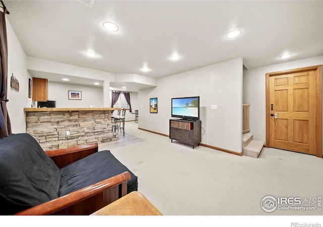 living room featuring light colored carpet and indoor bar