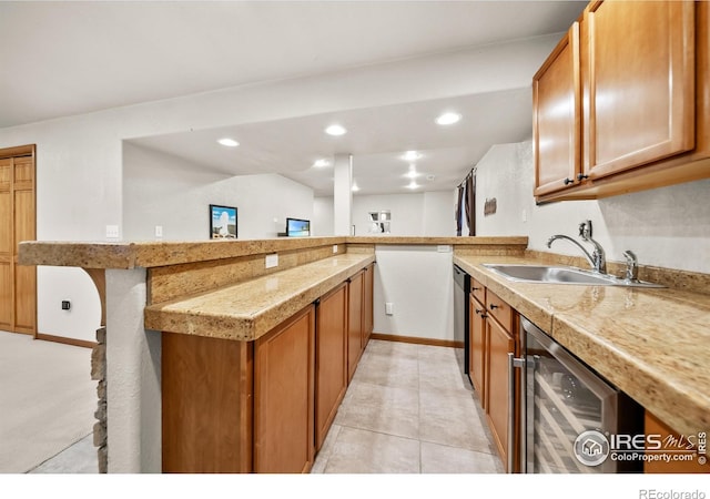 kitchen featuring sink, wine cooler, kitchen peninsula, a kitchen bar, and light tile patterned floors