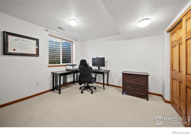 office space with a textured ceiling and carpet flooring