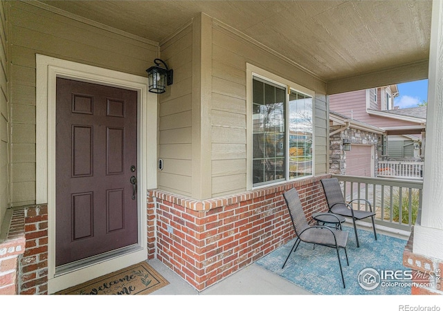 entrance to property featuring a garage and a porch