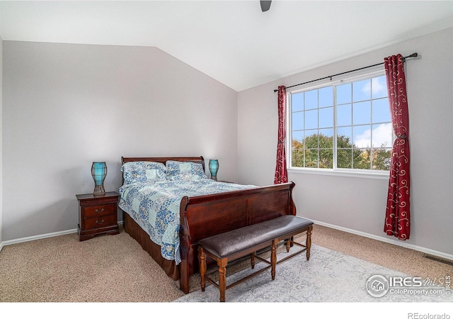 bedroom with lofted ceiling, light colored carpet, and ceiling fan