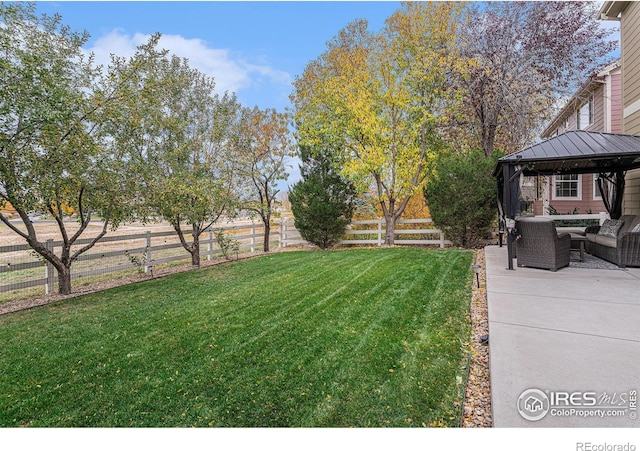 view of yard featuring outdoor lounge area, a gazebo, and a patio area