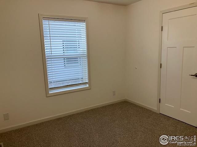 unfurnished room featuring carpet flooring