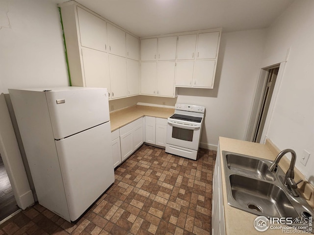 kitchen featuring white appliances, white cabinetry, light countertops, and a sink