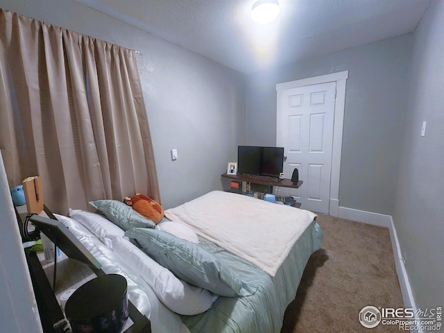 bedroom featuring carpet flooring and baseboards