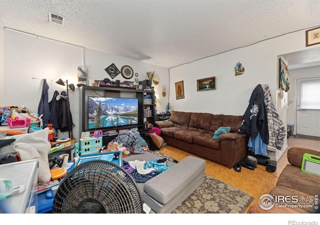 living room featuring hardwood / wood-style floors and a textured ceiling