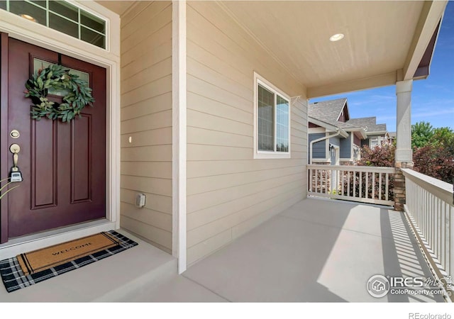 view of exterior entry with a porch