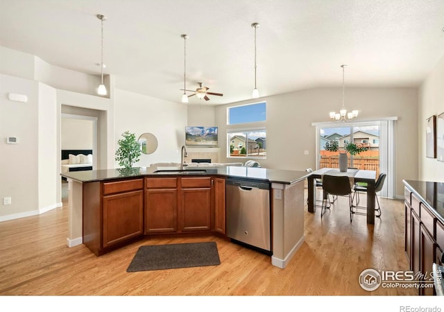 kitchen with dishwasher, a wealth of natural light, sink, and a kitchen island with sink