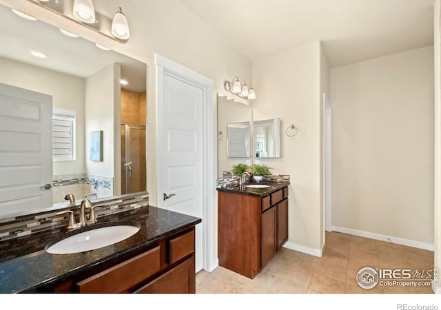 bathroom featuring walk in shower, vanity, and tile patterned floors