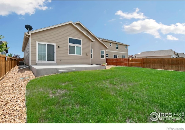 rear view of house featuring a patio area and a lawn