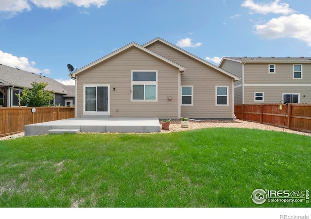 back of house featuring a patio and a yard