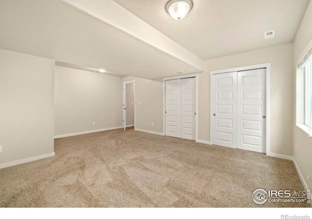 unfurnished bedroom with light carpet