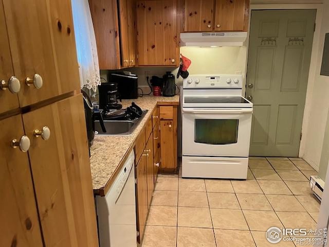 kitchen featuring a baseboard radiator, light stone counters, light tile patterned flooring, and white appliances