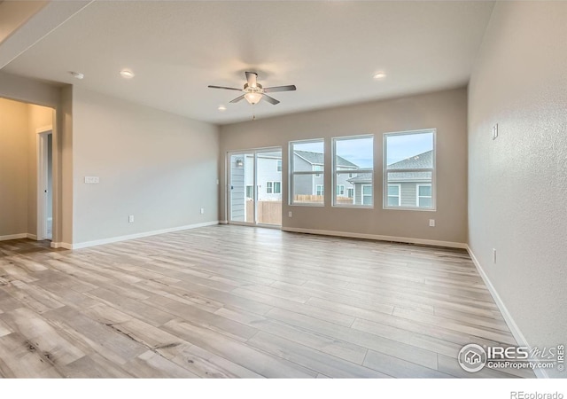 spare room with ceiling fan and light hardwood / wood-style floors