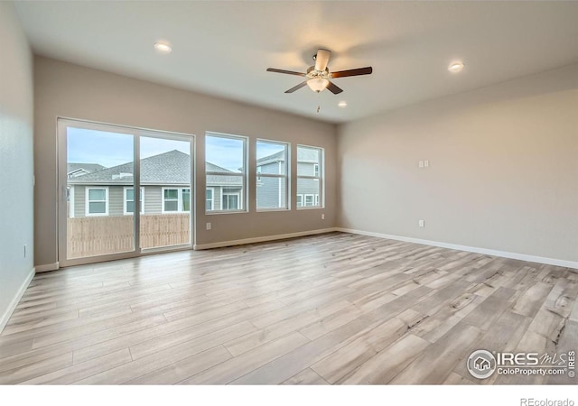 unfurnished room with ceiling fan and light hardwood / wood-style floors