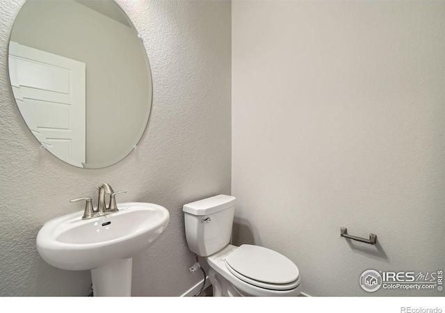 bathroom with sink and toilet