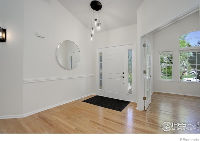 entryway featuring hardwood / wood-style floors and lofted ceiling