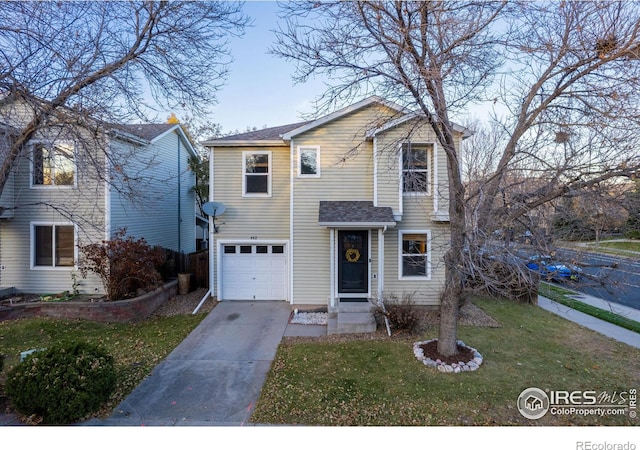 view of front property featuring a front yard and a garage