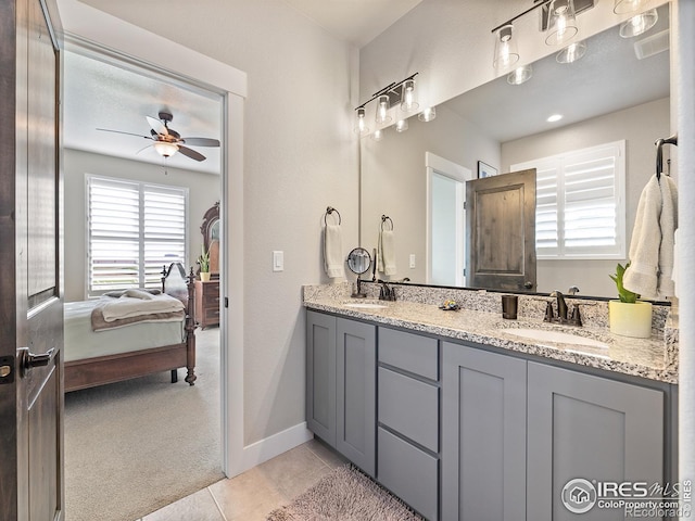 full bathroom with double vanity, connected bathroom, a sink, and tile patterned floors