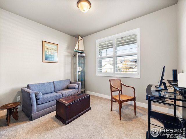 carpeted living room featuring baseboards