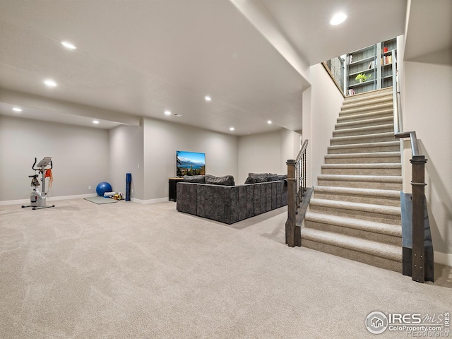 living room featuring stairs, carpet, baseboards, and recessed lighting