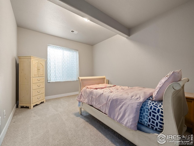 bedroom with visible vents, light carpet, and baseboards