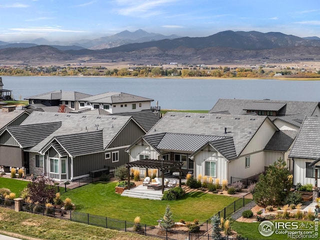 drone / aerial view with a water and mountain view